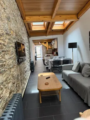 a living room with a couch and a table at Casa Alameda 23 de Casas Das Figueiras en Ría Eo-Ribadeo in Castropol