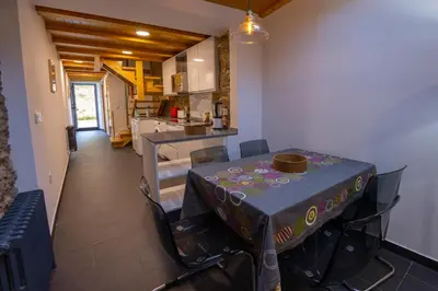 a kitchen with a table with a table cloth on it at Casa Alameda 23 de Casas Das Figueiras en Ría Eo-Ribadeo in Castropol