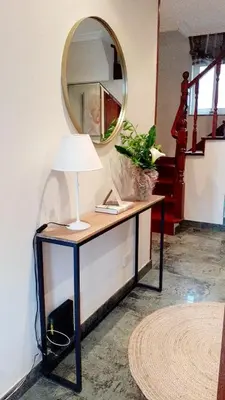 a table with a lamp and a mirror on a wall at Lucus Dúplex in Lugo