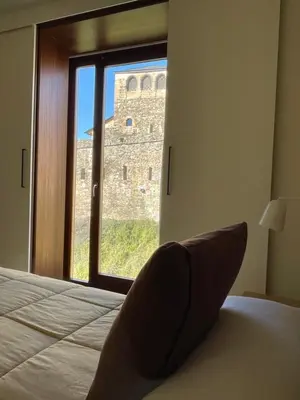 a room with two beds and a desk in a room at APARTAMENTOS TURÍSTICOS GUIANA in Ponferrada