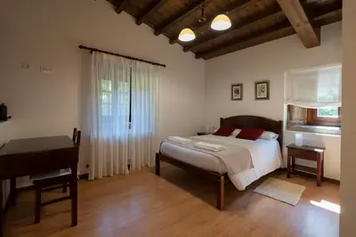a bedroom with a bed and a piano in it at Casa rural completa Río Sarela in Santiago de Compostela