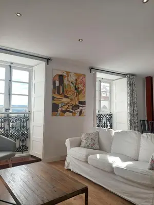a living room with a white couch and two windows at SAN FRANCISCO in Ribadeo