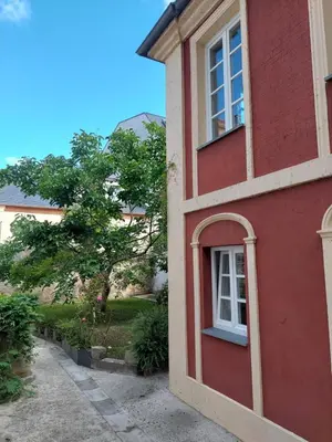 a red building with a window on the side of it at SAN FRANCISCO in Ribadeo