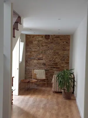 a living room with a brick wall and a chair at SAN FRANCISCO in Ribadeo