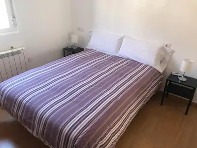 a bedroom with a large bed with two night stands at Polvorín in Ourense