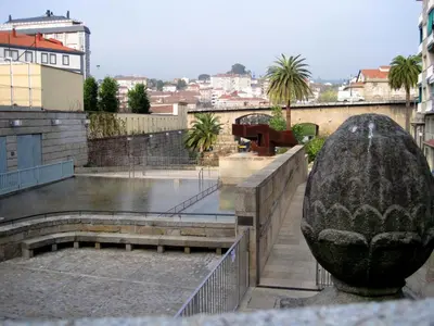 a statue of a vase on a balcony of a building at Polvorín in Ourense