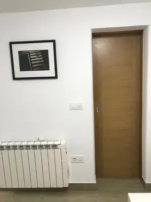 a hallway with a door and a picture on a wall at Polvorín in Ourense