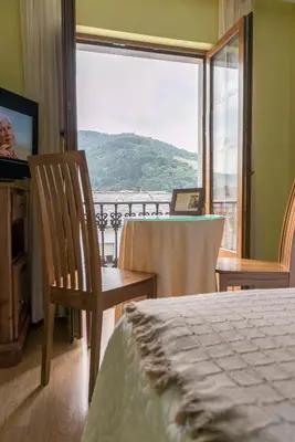 a room with a bed and a window with a view at Hotel Rural Casa Paulino in Taramundi
