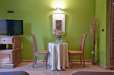 a room with a table with a vase of flowers on it at Hotel Rural Casa Paulino in Taramundi