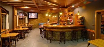 a bar in a restaurant with tables and chairs at Hotel Rural Casa Paulino in Taramundi