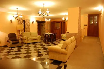 a living room with chairs and a checkered floor at Pacio do Sil in La Rúa