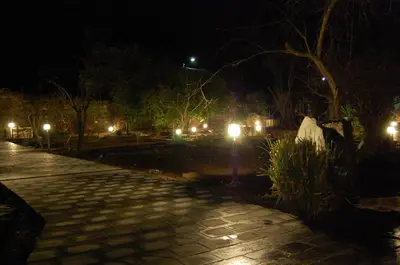 a park at night with lights on a sidewalk at Pacio do Sil in La Rúa