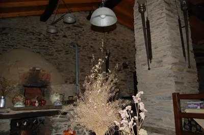 a room with a stone wall with a chandelier at Pacio do Sil in La Rúa