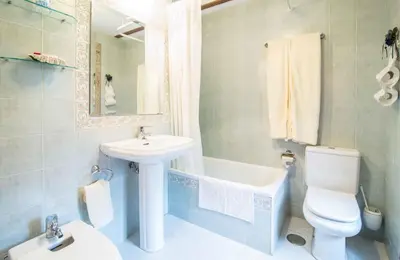 a bathroom with a sink and a toilet and a tub at Pazo Da Fraga in Albeos