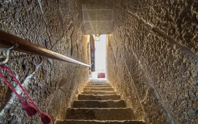 an alleyway with stairs in a stone wall at Pazo Da Fraga in Albeos