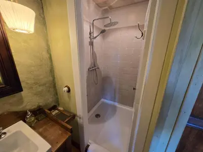 a bedroom with a large bed and a chair at Casa do Castelo de Andrade in Puentedeume