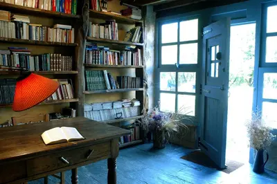 a bedroom with a large bed with two lamps at Casa do Castelo de Andrade in Puentedeume
