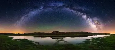 a starry night with a milky way over a lake at Vila Morena in Corzos