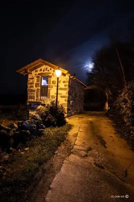 a house with a light on the side of a street at Vila Morena in Corzos
