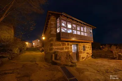 a building with a window on top of it at night at Vila Morena in Corzos
