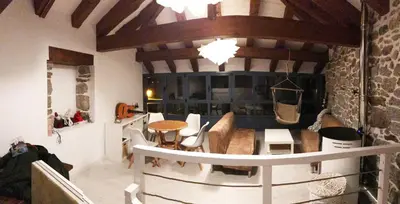 a living room with a table and chairs and a couch at Vila Morena in Corzos