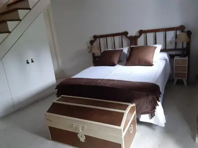a bedroom with a large bed with a trunk on it at Vila Morena in Corzos