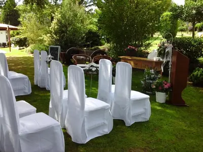 a row of white chairs sitting in a field at Hostal Restaurante O'Cadaval in Frades