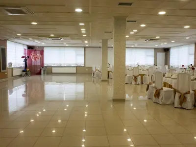 a large banquet hall with white tables and chairs at Hostal Restaurante O'Cadaval in Frades