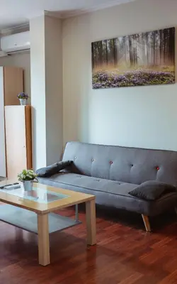 a living room with a blue couch and a coffee table at A Casa Antiga do Monte Apartamentos Turísticos - Pontecesures in Padrón