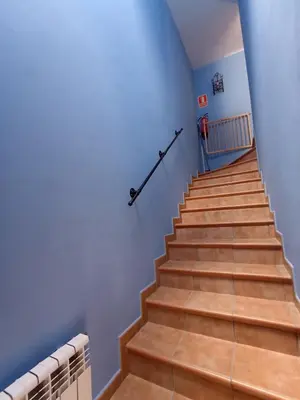 a stairway with wooden steps and a railing at CASA FELISA in Pola de Somiedo
