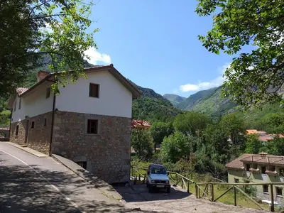 a small car parked next to a building at CASA FELISA in Pola de Somiedo
