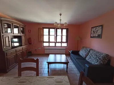 a living room with a couch and a table at CASA FELISA in Pola de Somiedo