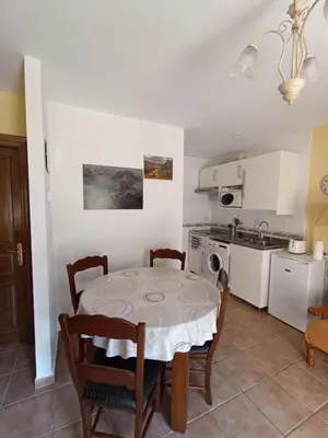 a kitchen and dining room with a table and chairs at CASA FELISA in Pola de Somiedo