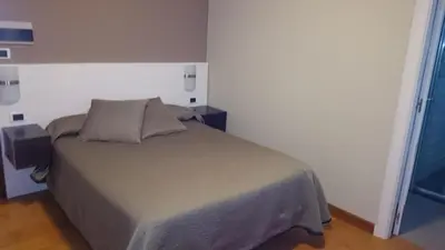 a bedroom with a bed in a white room at Hotel El Millón in Viveiro