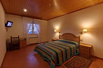 a bedroom with a bed and a television in it at Casa Cazoleiro in Meira