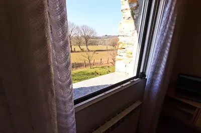 an open window with a view of a field at Casa Cazoleiro in Meira