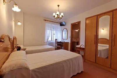 a hotel room with two beds and a mirror at Casa Cazoleiro in Meira
