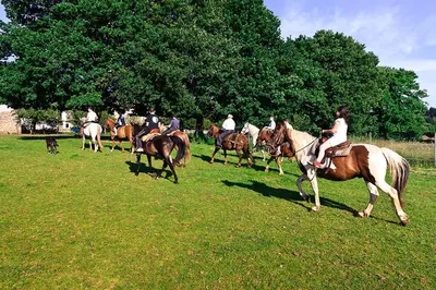 a group of people riding horses in a field at Casa Cazoleiro in Meira