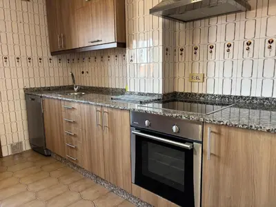a kitchen with wooden cabinets and a stove top oven at CASA MENCIA in Sober