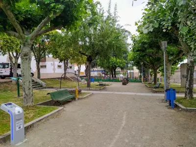 a park with benches and trees and a trash can at CASA MENCIA in Sober