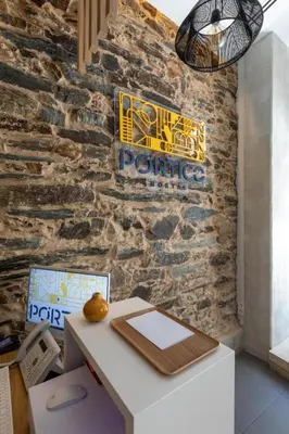 a white desk in front of a brick wall at Hostal Pórtico in Betanzos