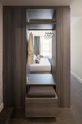 a walk in closet with a bed in a room at Hostal Pórtico in Betanzos
