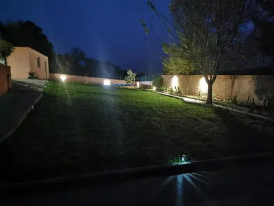 a yard at night with lights on the grass at CASA SEGADE in A Coruña
