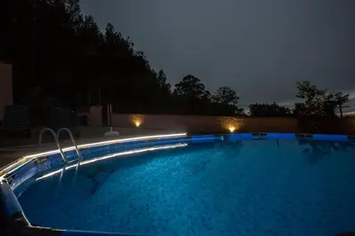a swimming pool at night with lights on it at CASA SEGADE in A Coruña