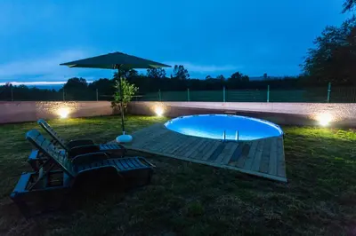 a pool with a table and an umbrella and chairs at CASA SEGADE in A Coruña