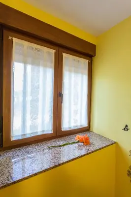 a window in a yellow room with a counter and a window at CASA SEGADE in A Coruña