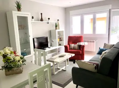 a living room with a couch and a tv at Apartamento Adelina in Silleda