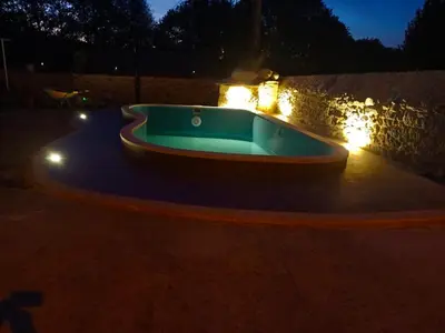 a jacuzzi tub in a backyard at night at Casa Cabaleira in Silleda