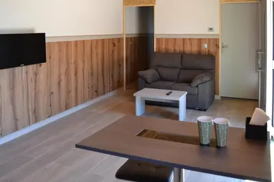 a living room with a couch and a table at CELTAINER in Maceda