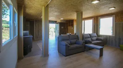 a living room with two couches and a table at CELTAINER in Maceda